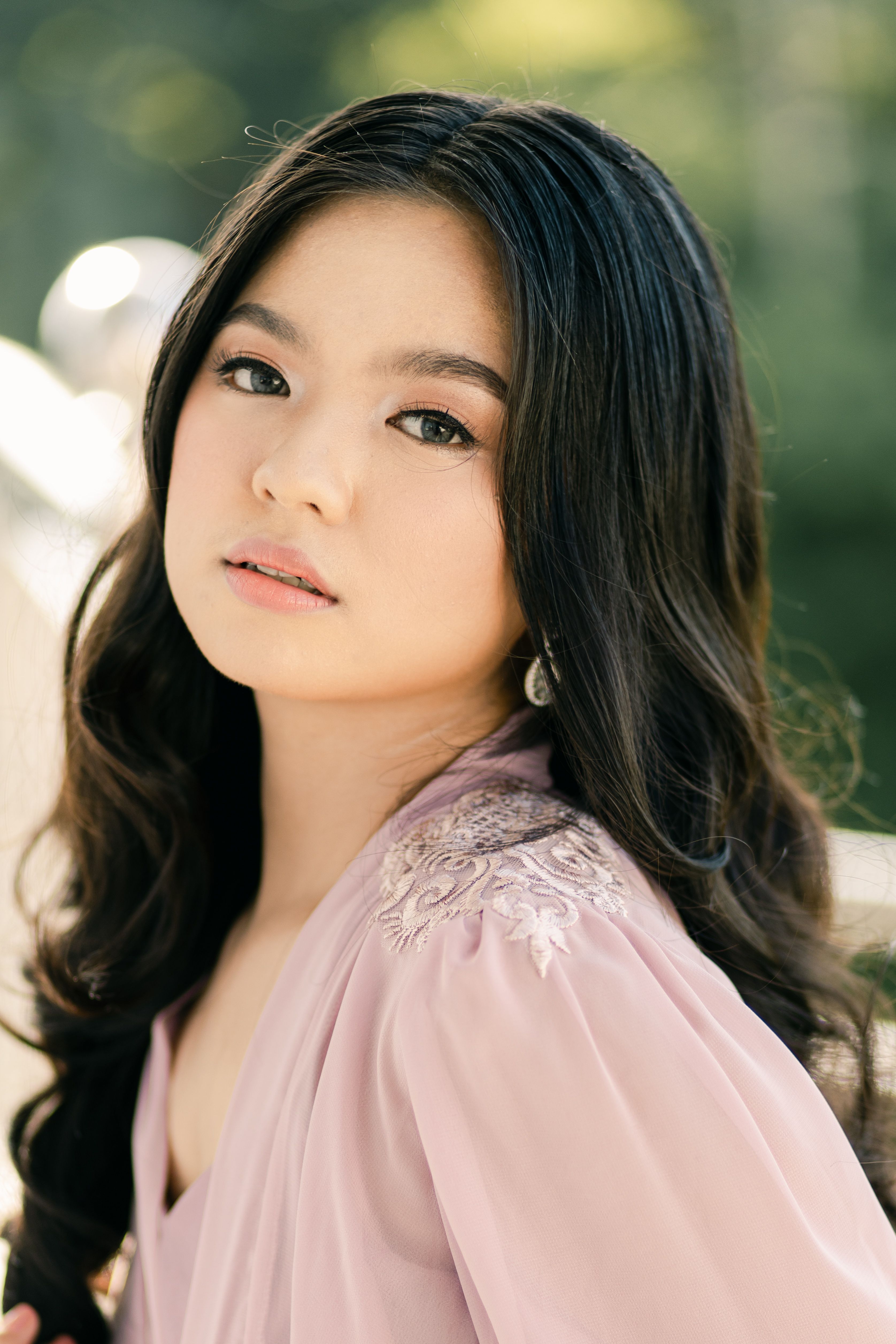 Stunning portrait of a young woman in natural light, exuding grace.