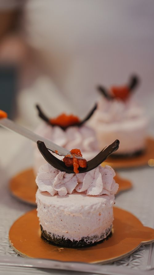 Free Exquisite pink mousse cakes topped with chocolate and fruit, perfect for dessert lovers. Stock Photo