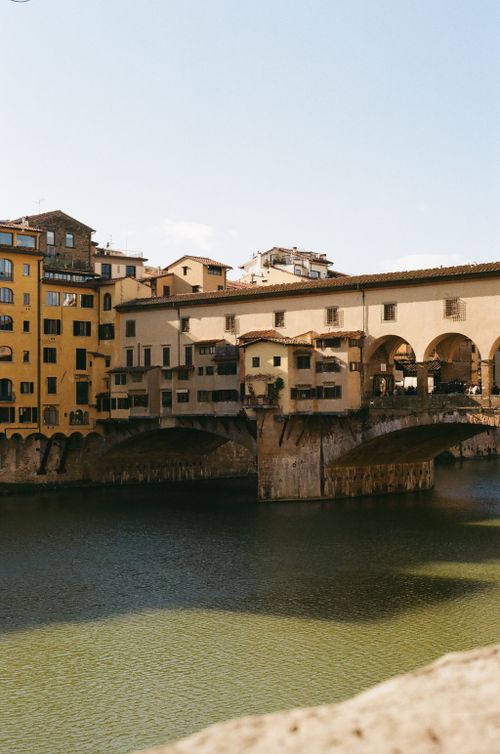 Free Historic Ponte Vecchio bridge under a clear blue sky in Florence, Tuscany. Stock Photo