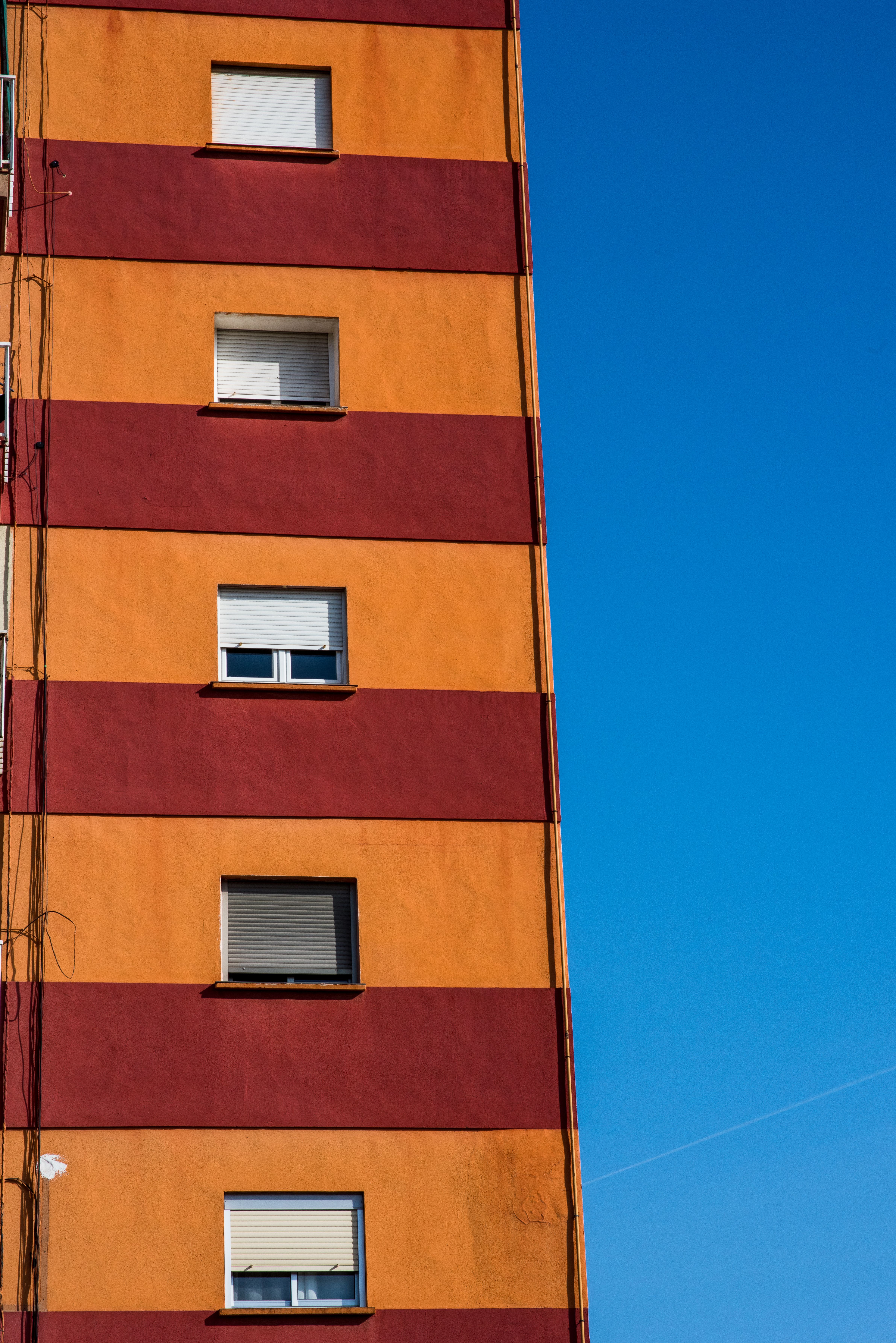 Colorful Building Facade against Clear Blue Sky · Free Stock Photo