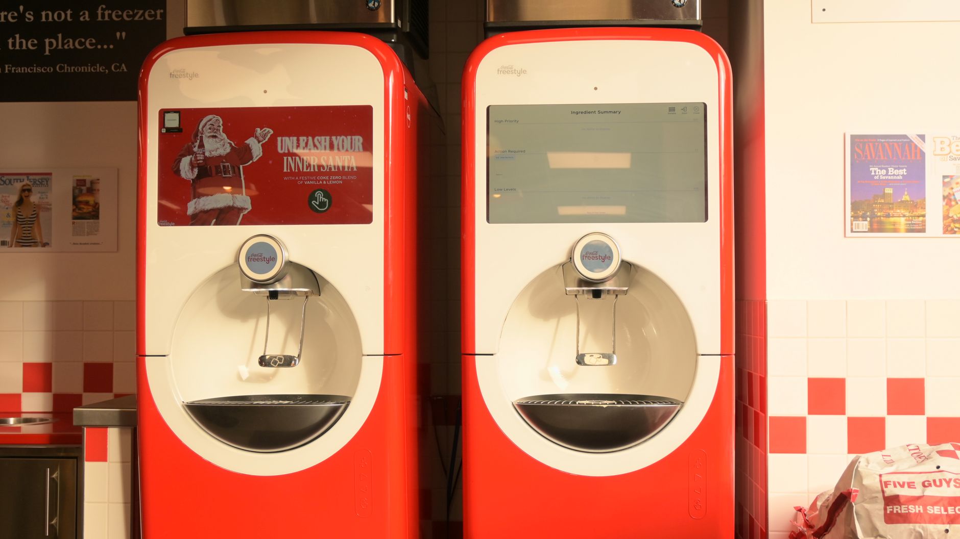 Coca-Cola Freestyle beverage dispensers in a restaurant with seasonal Santa branding.