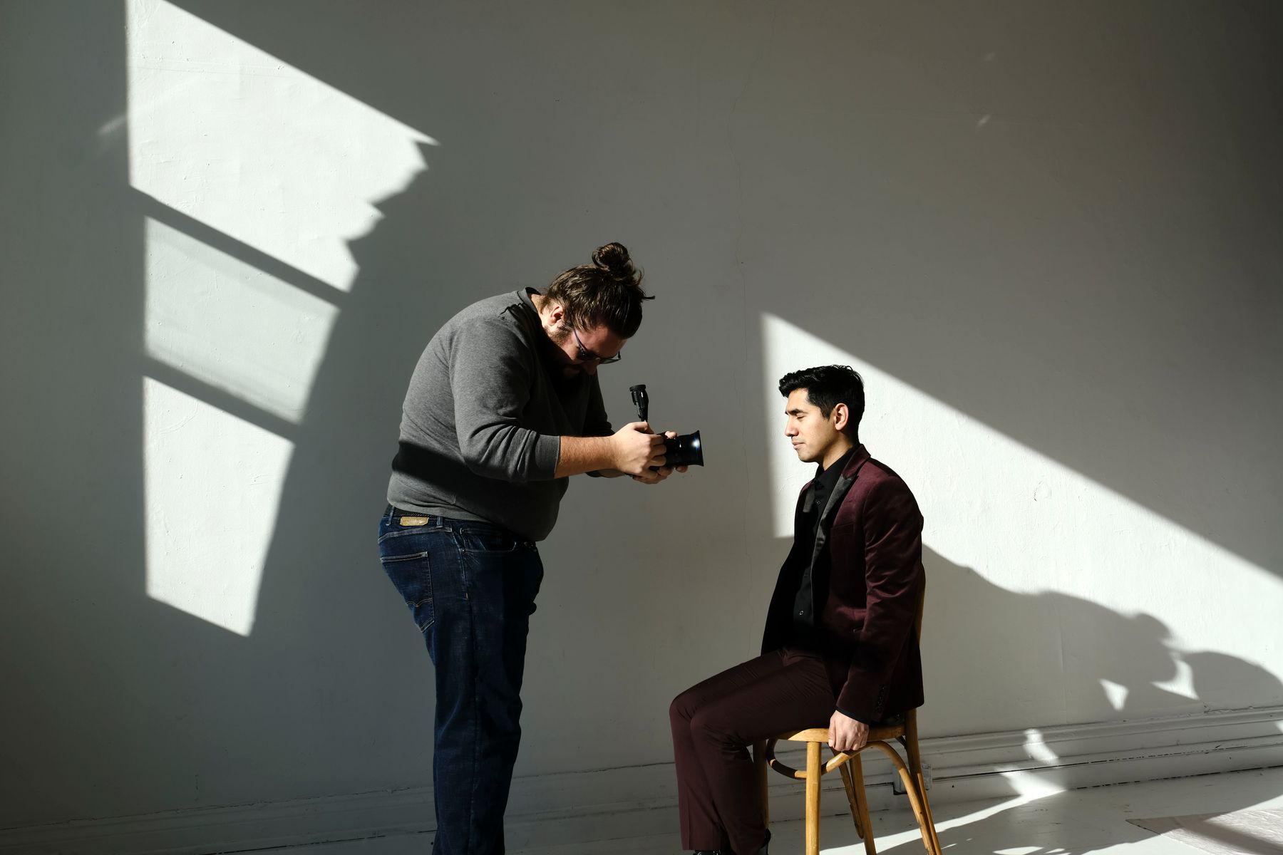 Photographer shooting with natural light in the studio