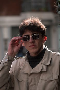 A fashionable young man wearing sunglasses on the streets of Buenos Aires, Argentina.