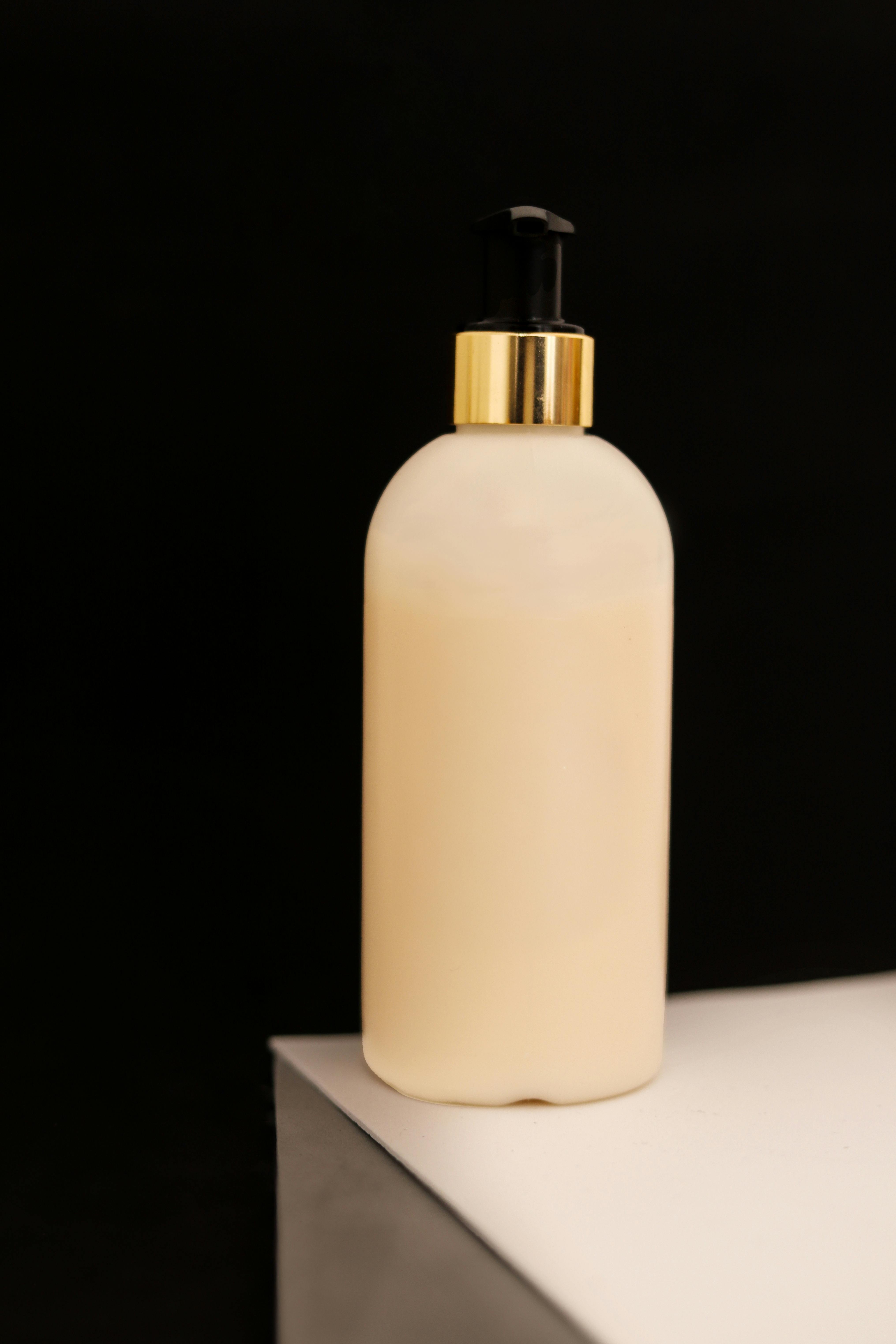 elegant cream bottle on stylish white surface