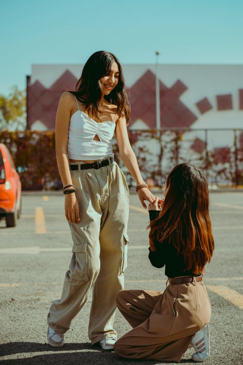 Free Heartwarming proposal moment between two young women in a casual urban setting. Stock Photo