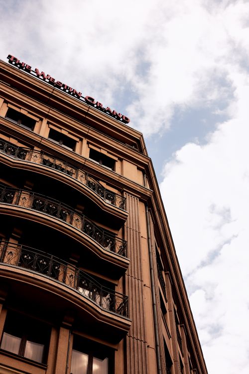 Free Architectural view of The Westin Grand hotel facade with ornate balconies and clear sky backdrop. Stock Photo