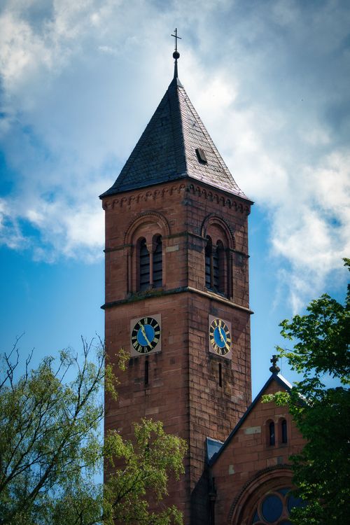 Free Charming clock tower against a blue sky in Bad Herrenalb, highlighting historic architecture. Stock Photo