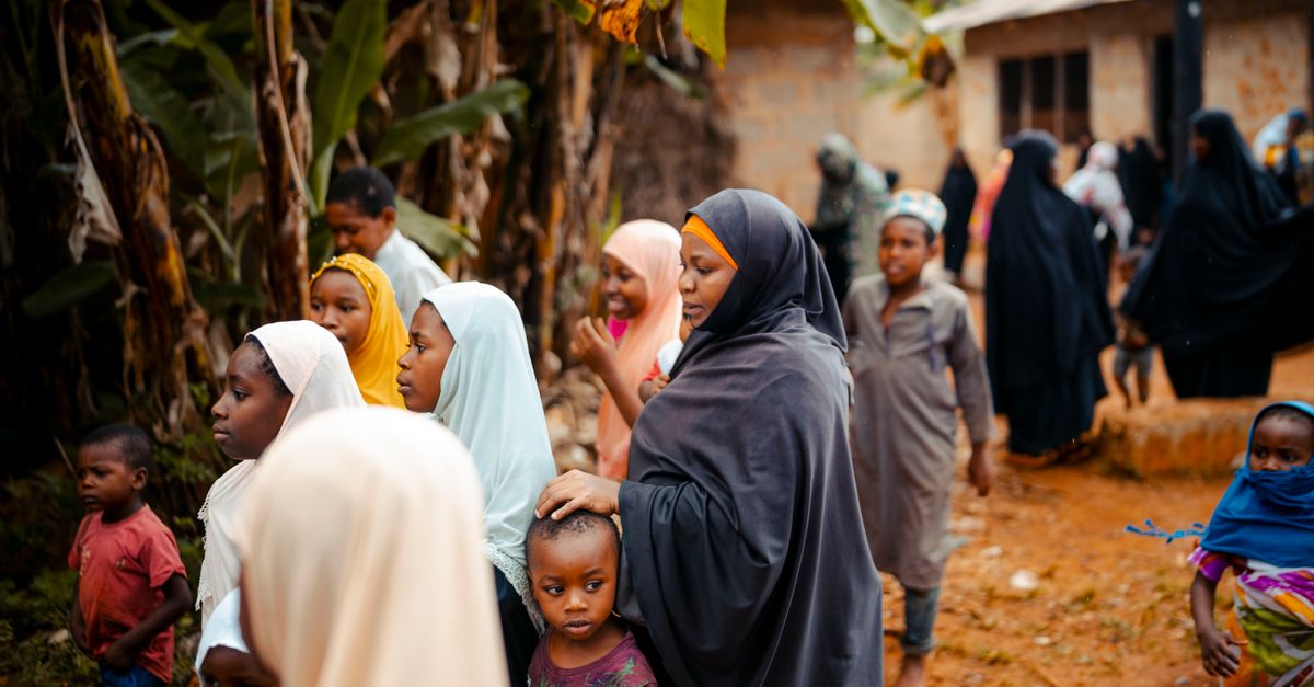 People gathered in a community fellowship setting in Ho, Ghana during evening hours