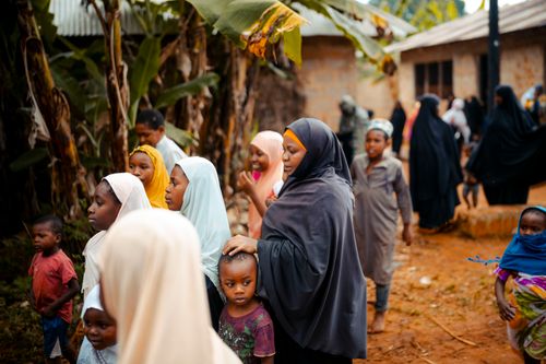 Free A vibrant scene of women and children in a bustling village community outdoors. Stock Photo