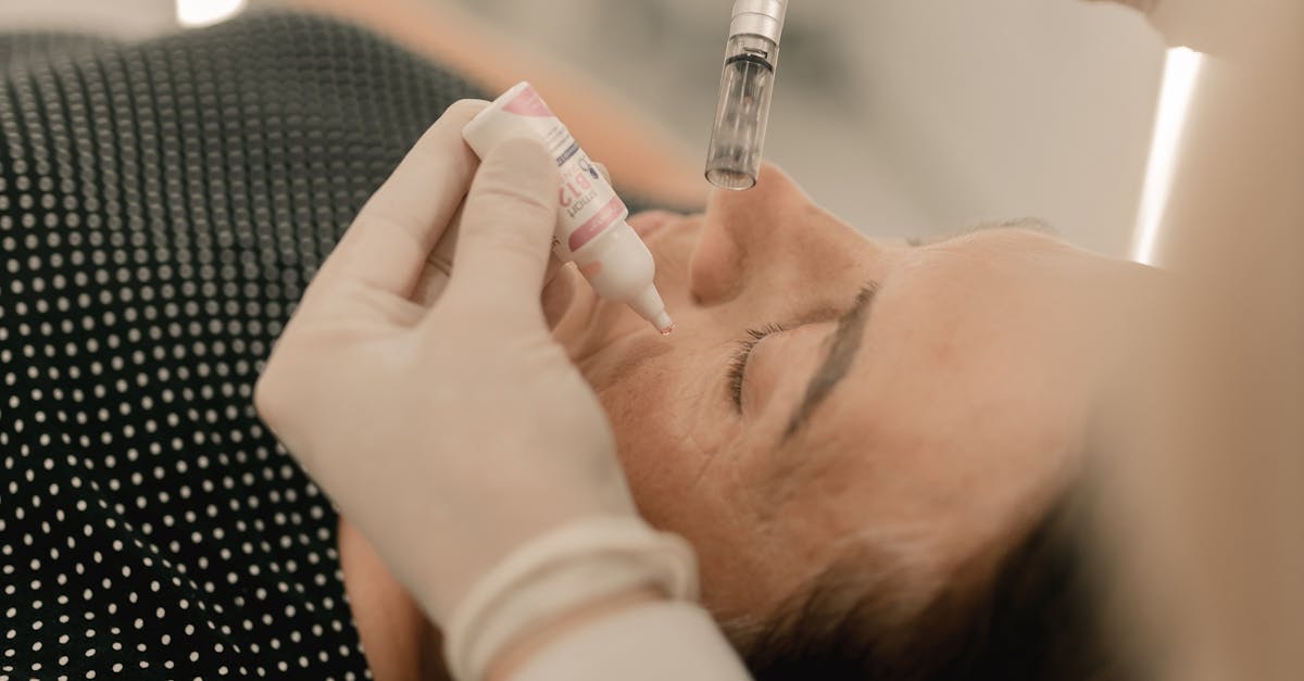 Woman applying too much face cream in her hand.