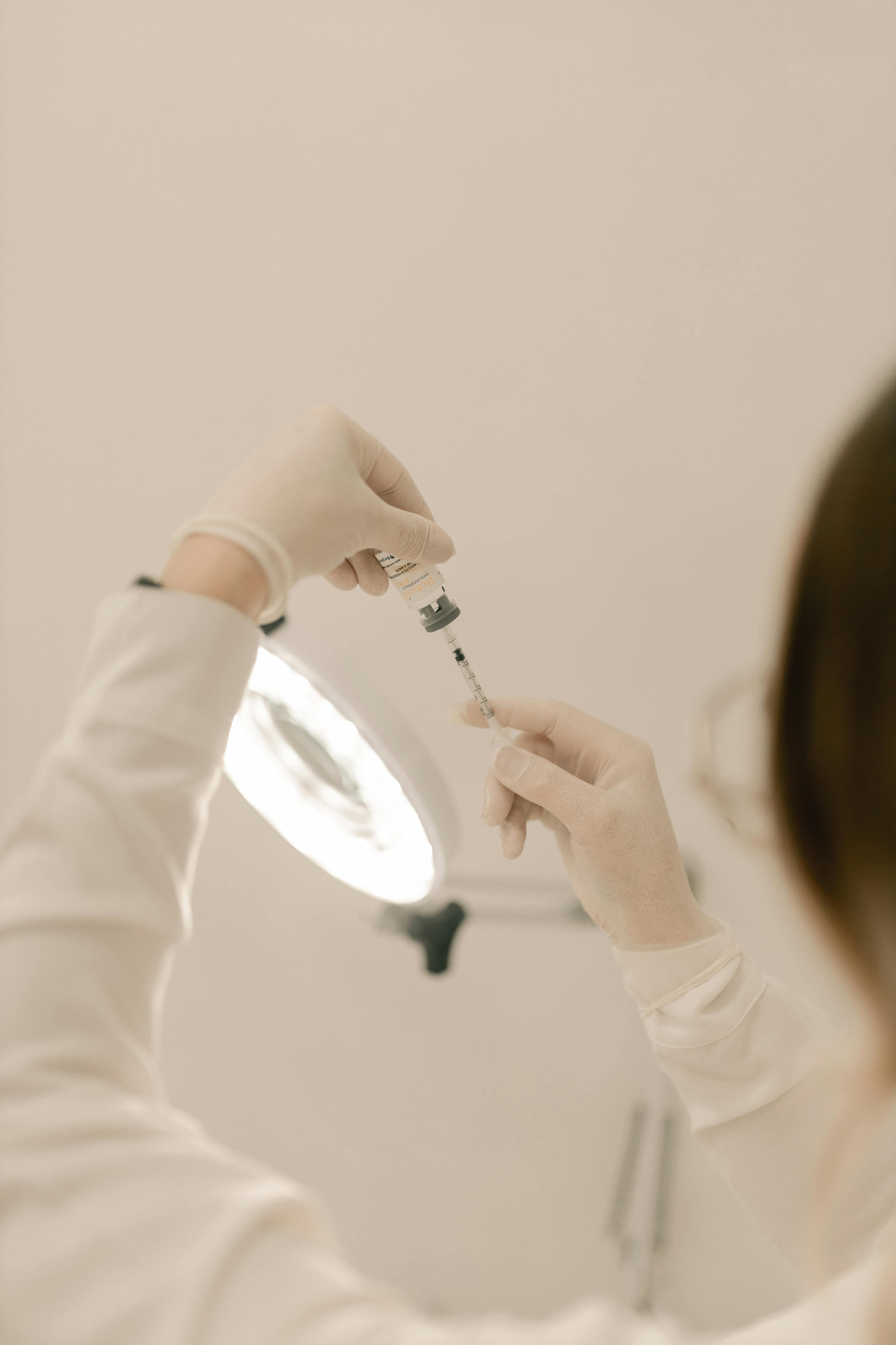 scientist preparing syringe in laboratory setting