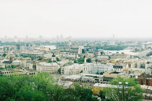 Free Aged residential building facades near church and river under sky with horizon in town Stock Photo