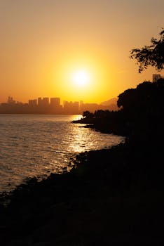 Stunning sunset over Shenzhen city skyline with waterfront view, China.