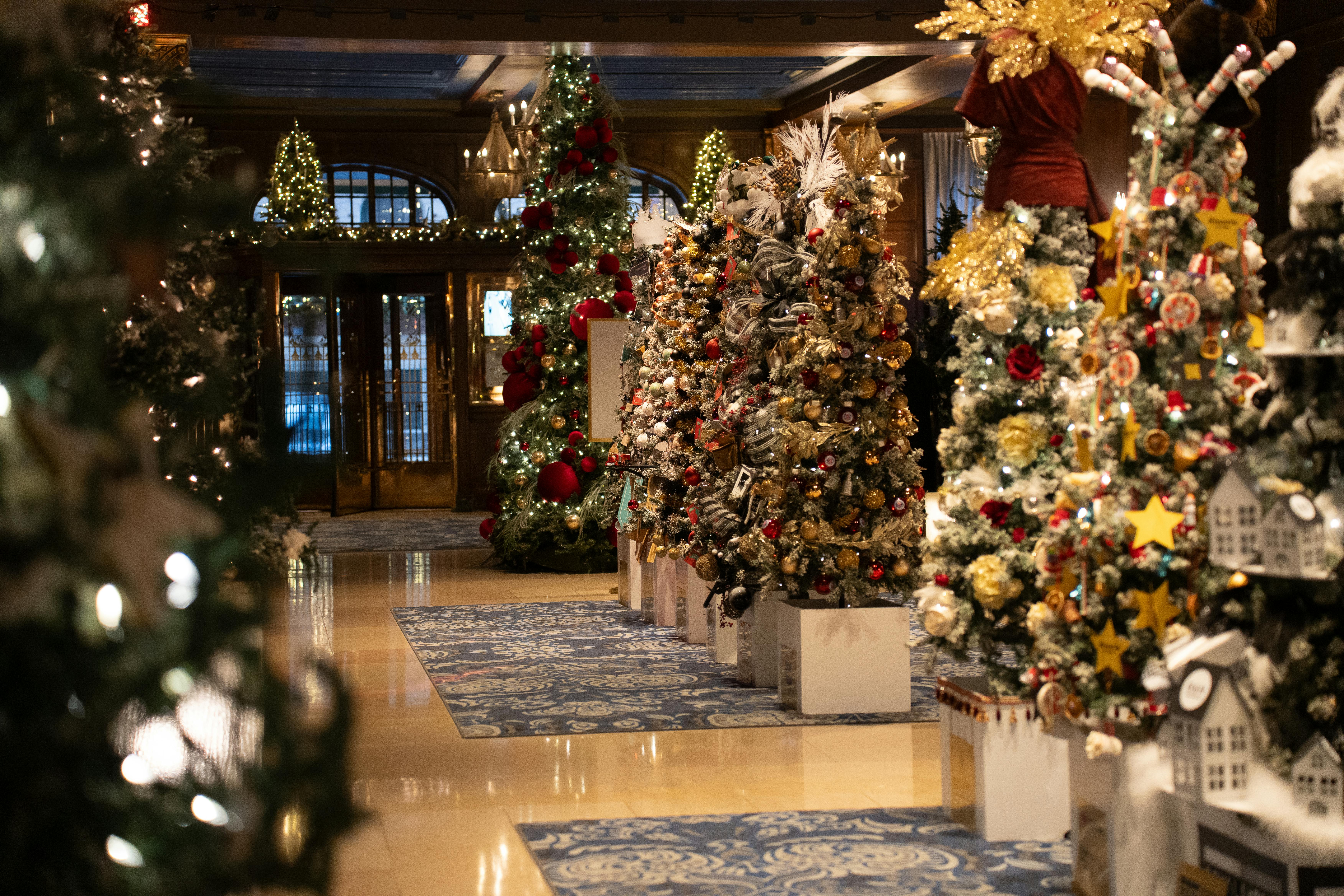 elegant christmas trees decorate hotel lobby