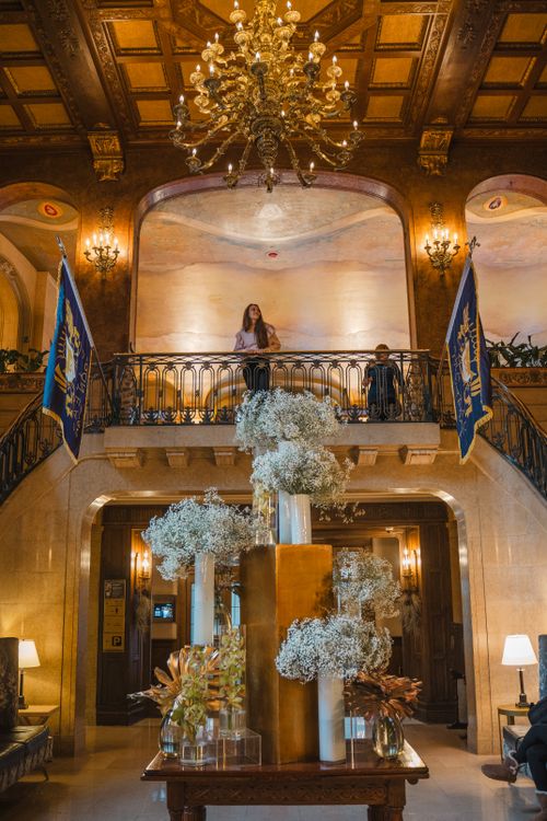 Free Luxurious hotel lobby in Québec with a grand chandelier and floral decorations. Stock Photo