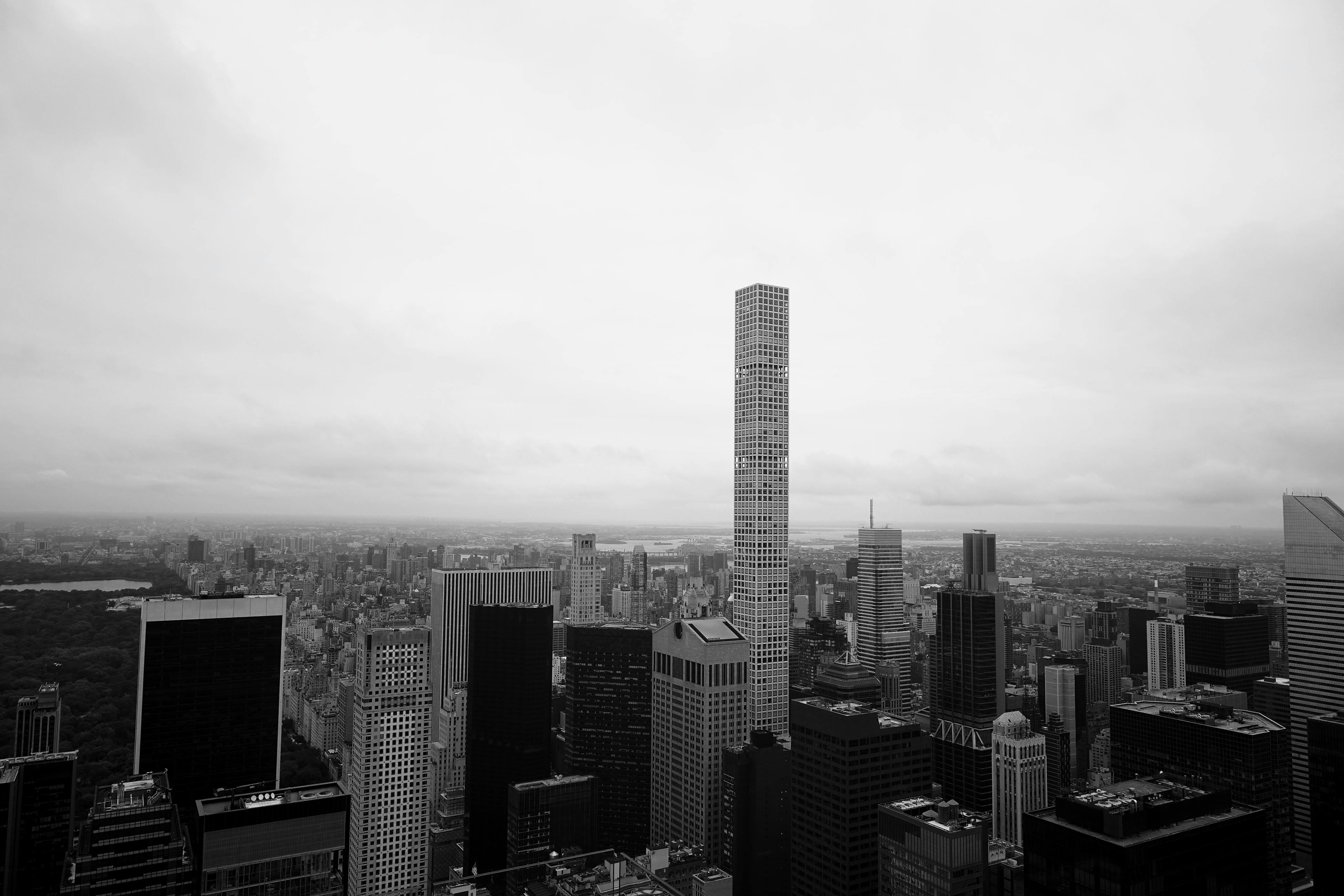 Black and white view of New York City's skyline featuring tall skyscrapers, and Central Park.