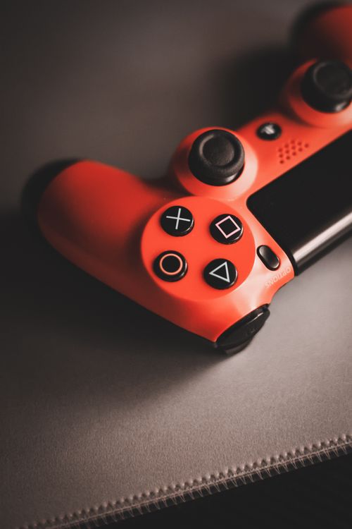 Free Red vintage game controller on a surface, showcasing nostalgic gaming design. Stock Photo