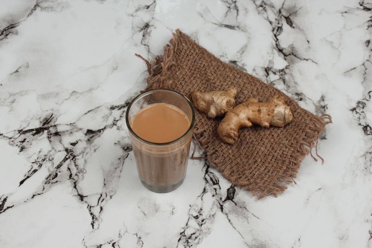 Traditional Indian masala chai served with fresh ginger