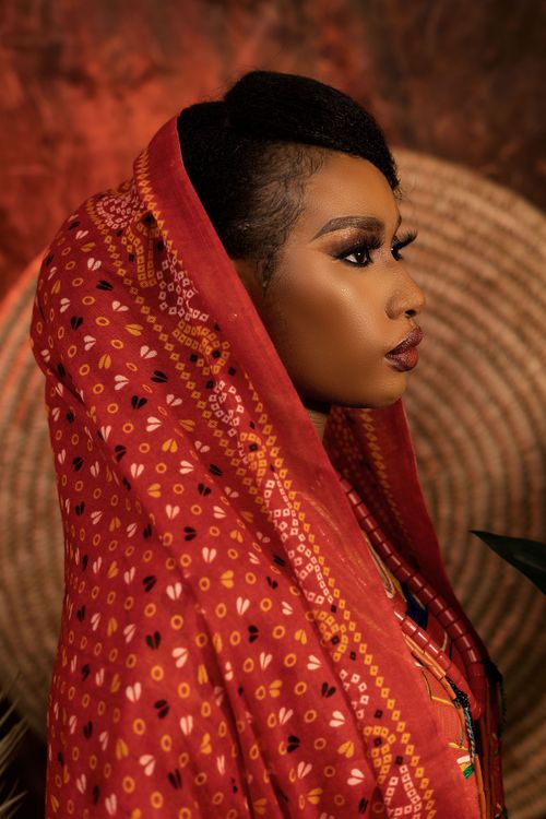 Free Close-up portrait of a woman wearing vibrant traditional clothing, exuding elegance. Stock Photo
