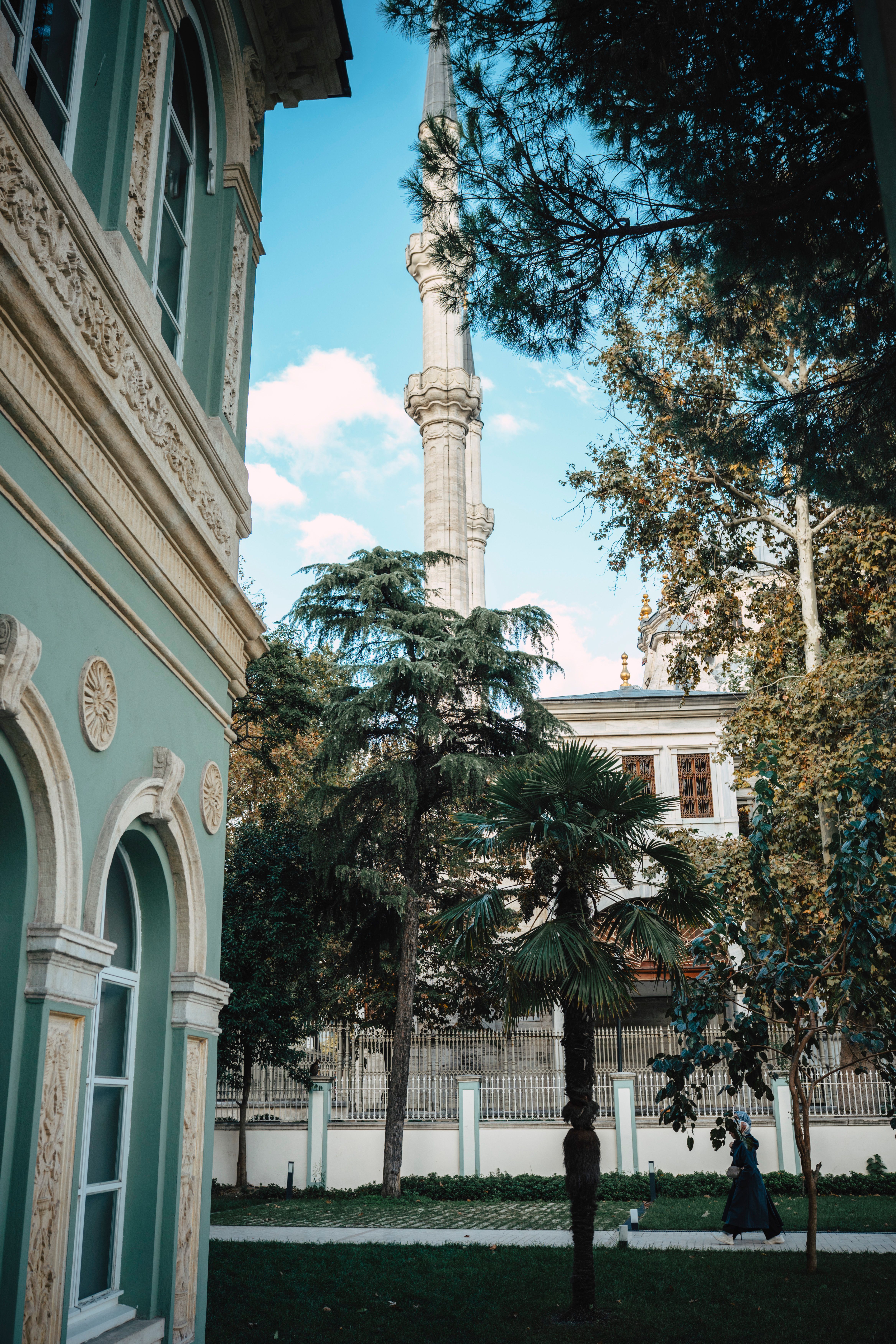 Ornate Mosque Minaret with Lush Gardens in Spring · Free Stock Photo