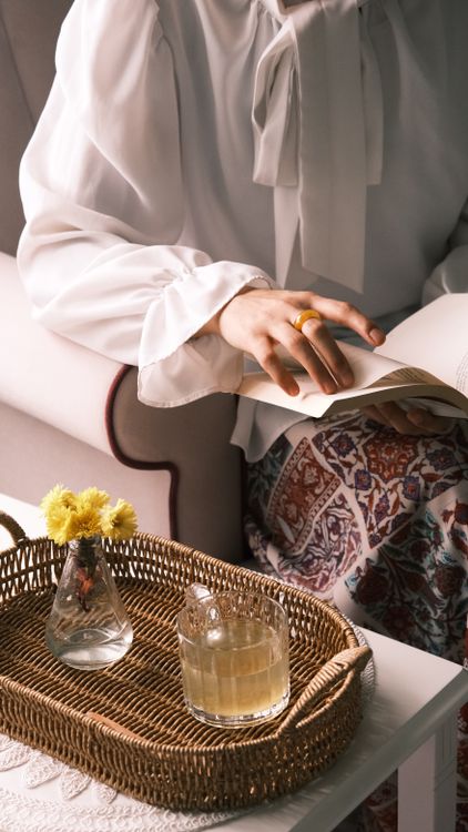 Cozy Reading Session with Tea and Flowers · Free Stock Photo