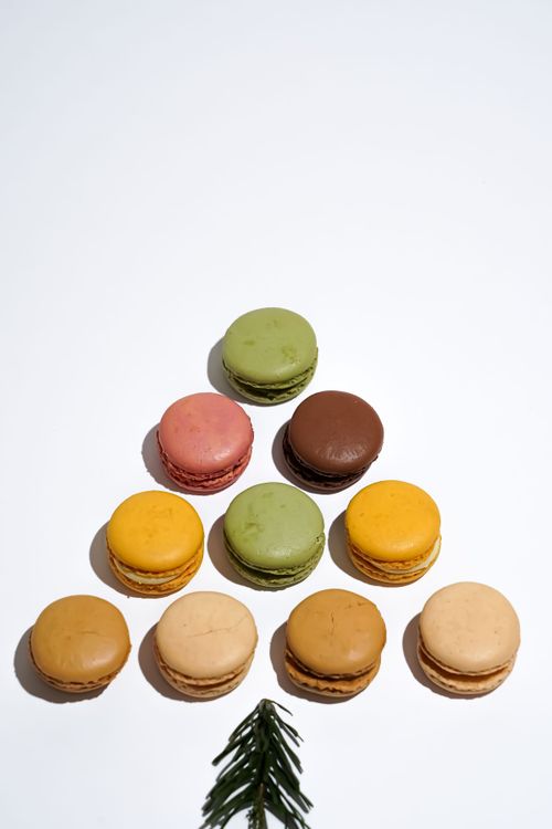 Free Vibrant assorted macarons shaped like Christmas tree on white background. Stock Photo