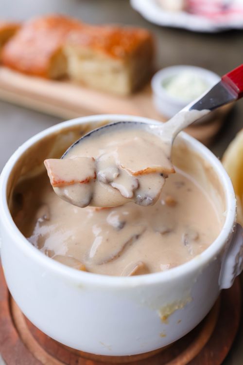 Free Delicious creamy mushroom soup garnished with bacon in a white bowl. Stock Photo