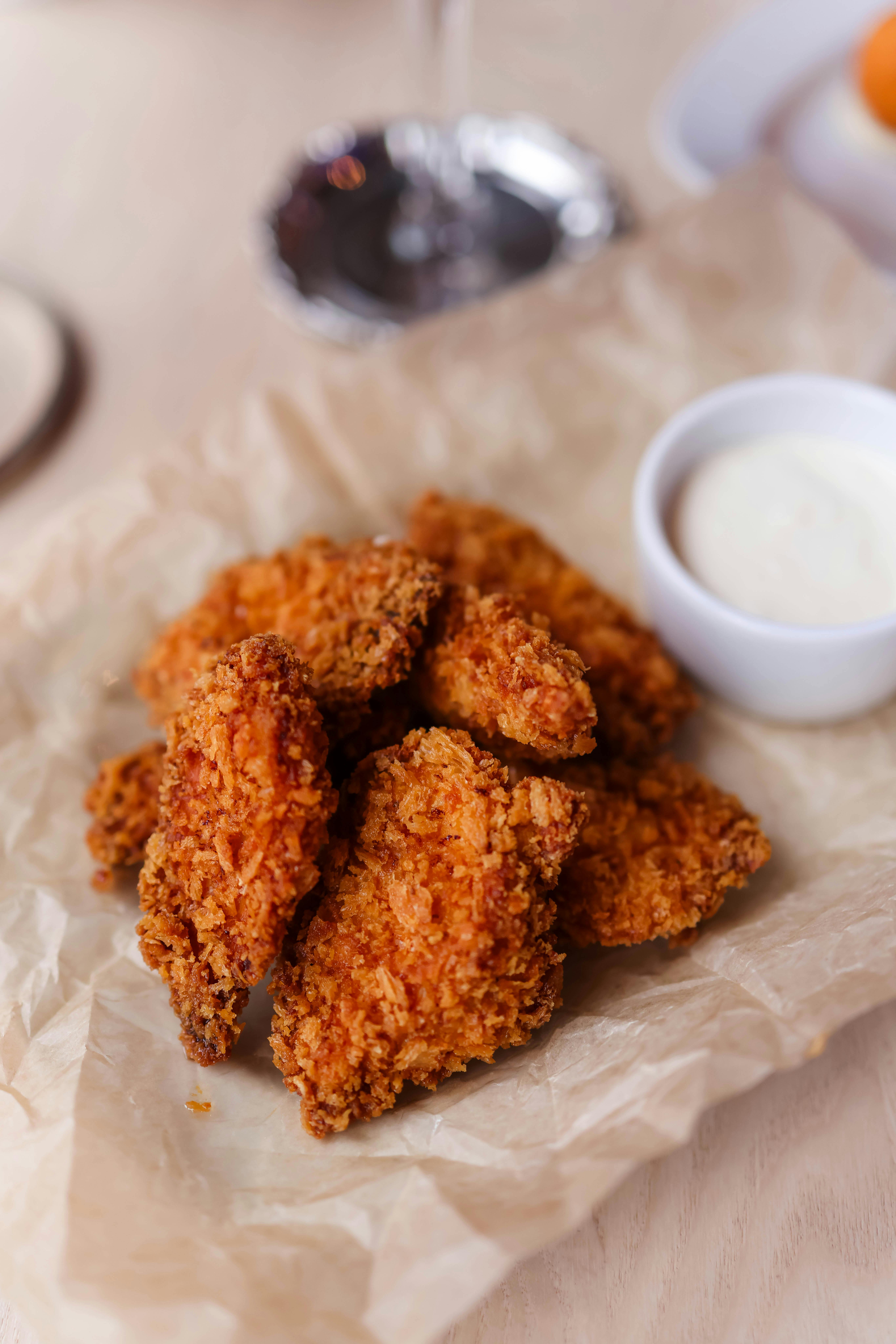 crispy fried chicken with dipping sauce on paper