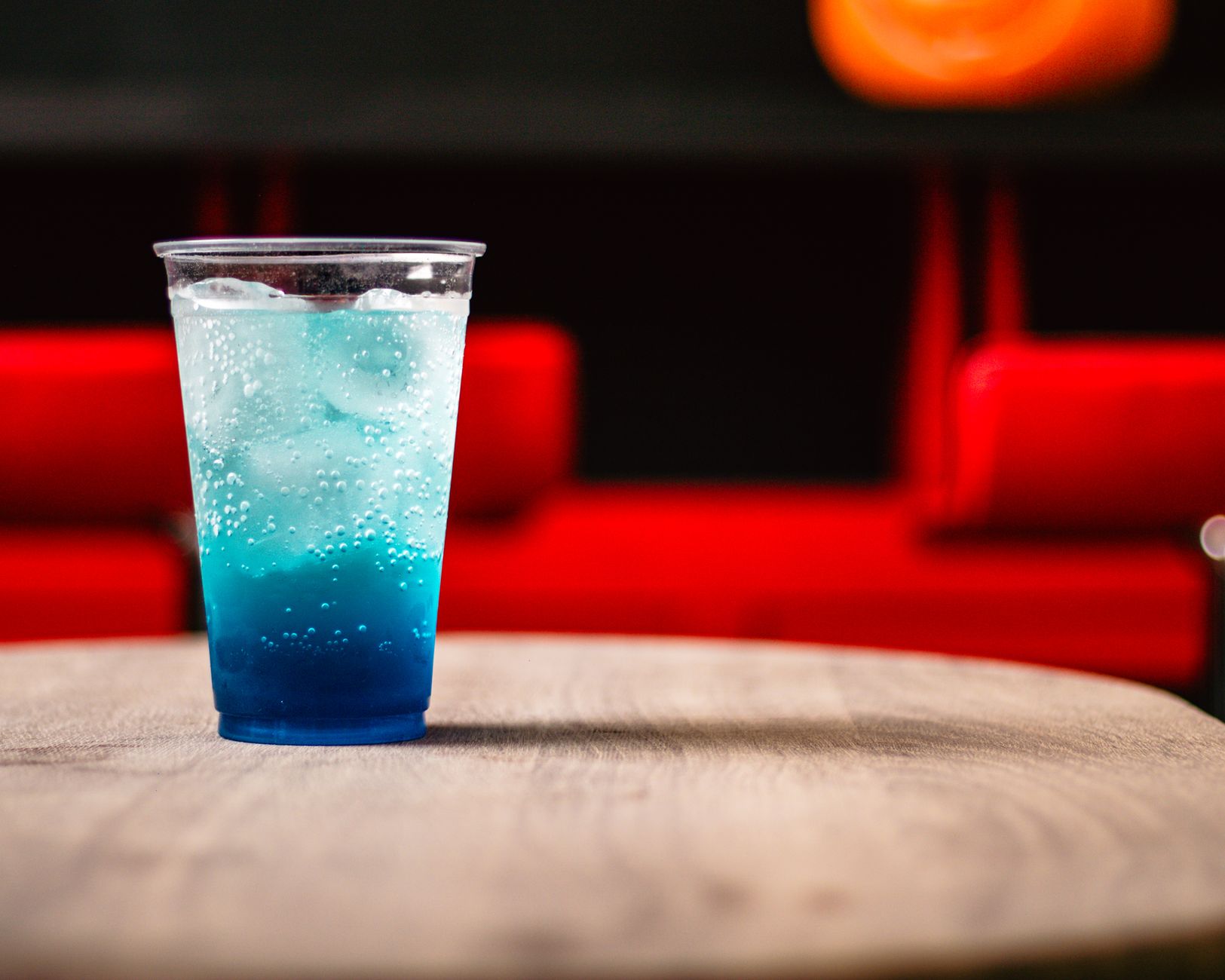 Glass of homemade Baja Blast drink with ice on a wooden table