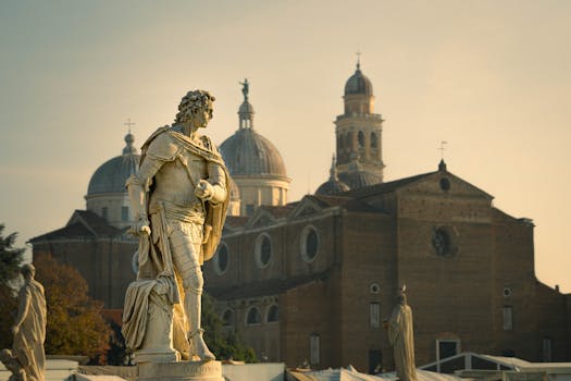 Vintage Roman statue with backdrop of historic Italian basilica in soft light.