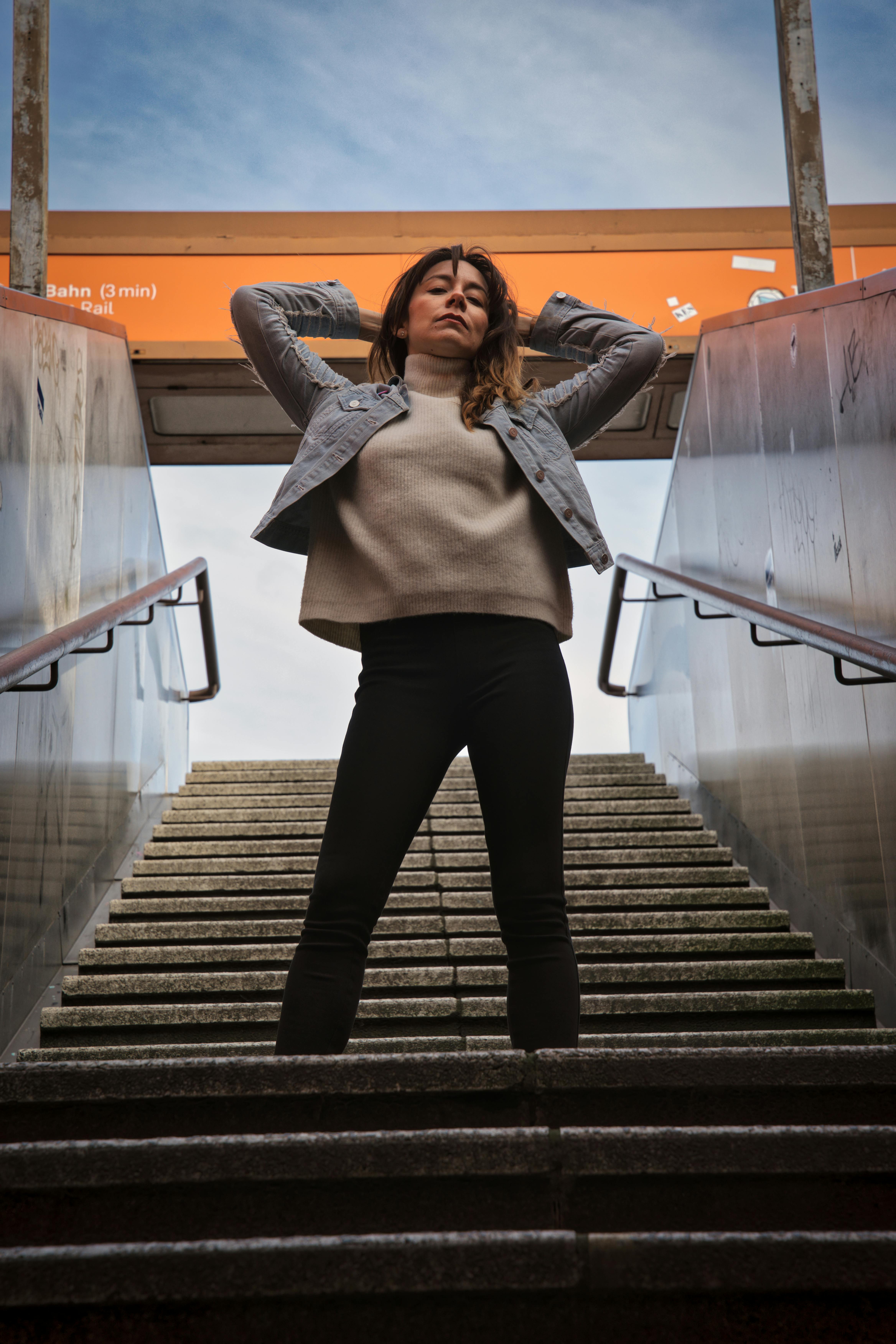 confident woman posing on urban staircase in berlin