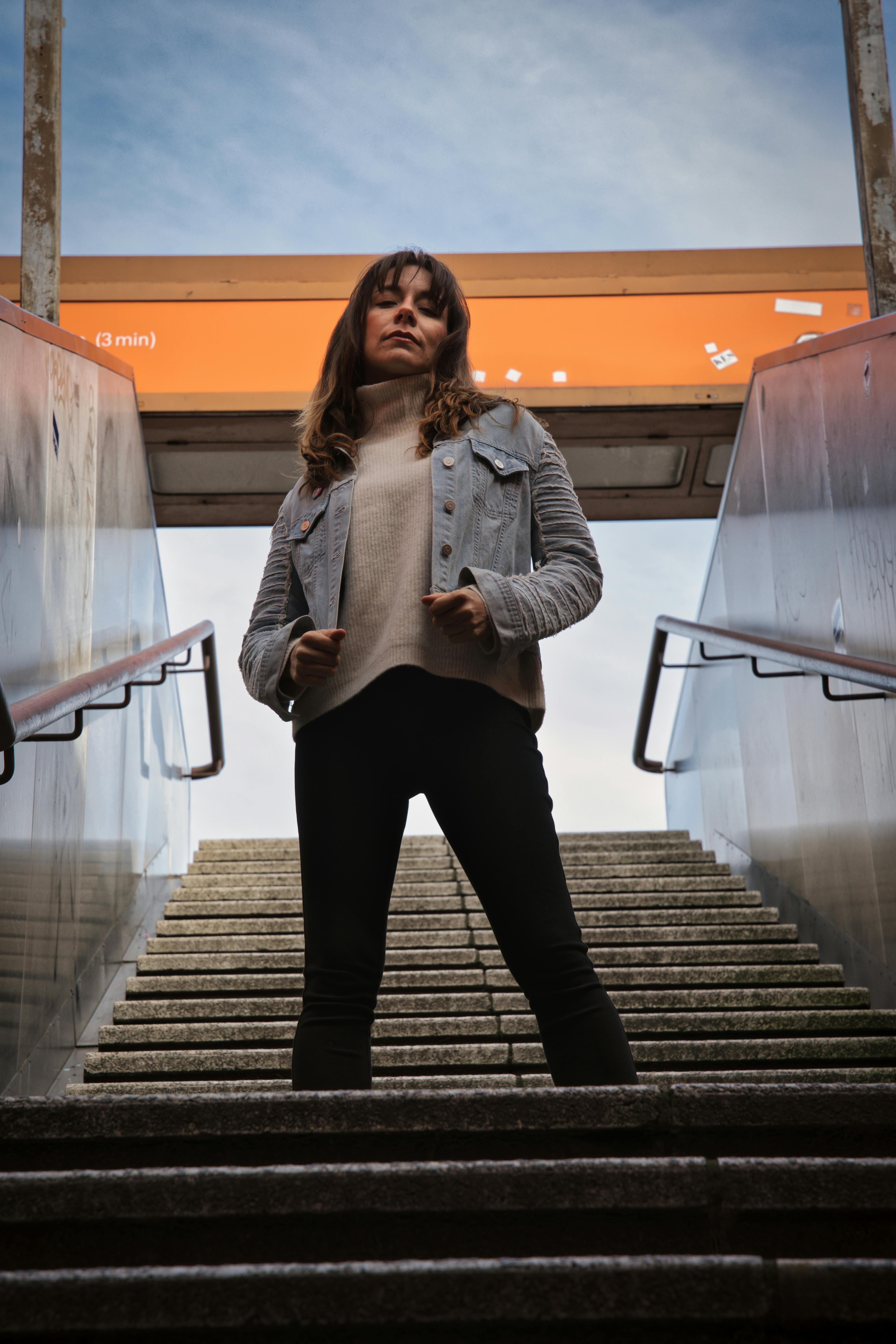 stylish woman posing in urban metro entrance