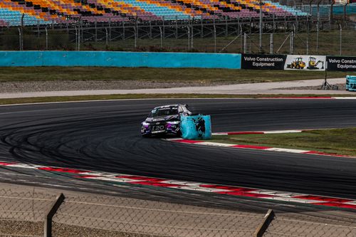 Free A thrilling rally race car navigates a sharp curve on a speed track, capturing the intensity of motorsport racing. Stock Photo
