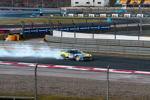 Free Exciting car drifting on a professional racing circuit, showcasing skill and speed. Stock Photo