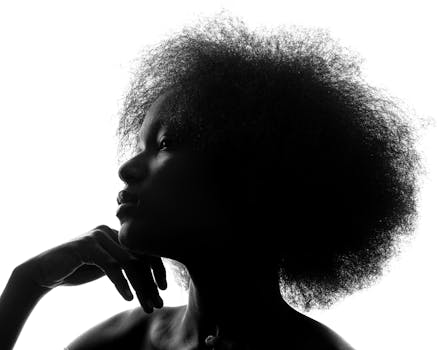 Striking silhouette portrait of a woman with afro hair in Lagos. Captivating and artistic.