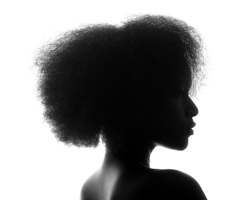 Free Dramatic black and white silhouette of a woman with afro hair. Artistic and elegant capture. Stock Photo