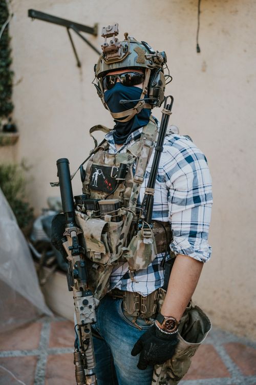 Free A soldier geared up with tactical equipment positioned outdoors. Ideal for military and security themes. Stock Photo