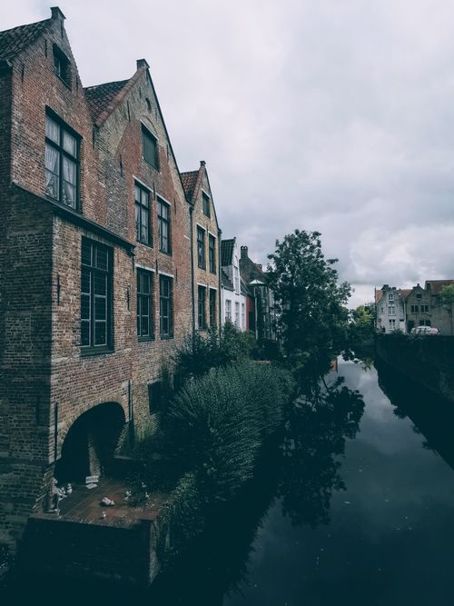 Free Quaint canal-side view of brick houses in Bruges, capturing the essence of medieval architecture. Stock Photo
