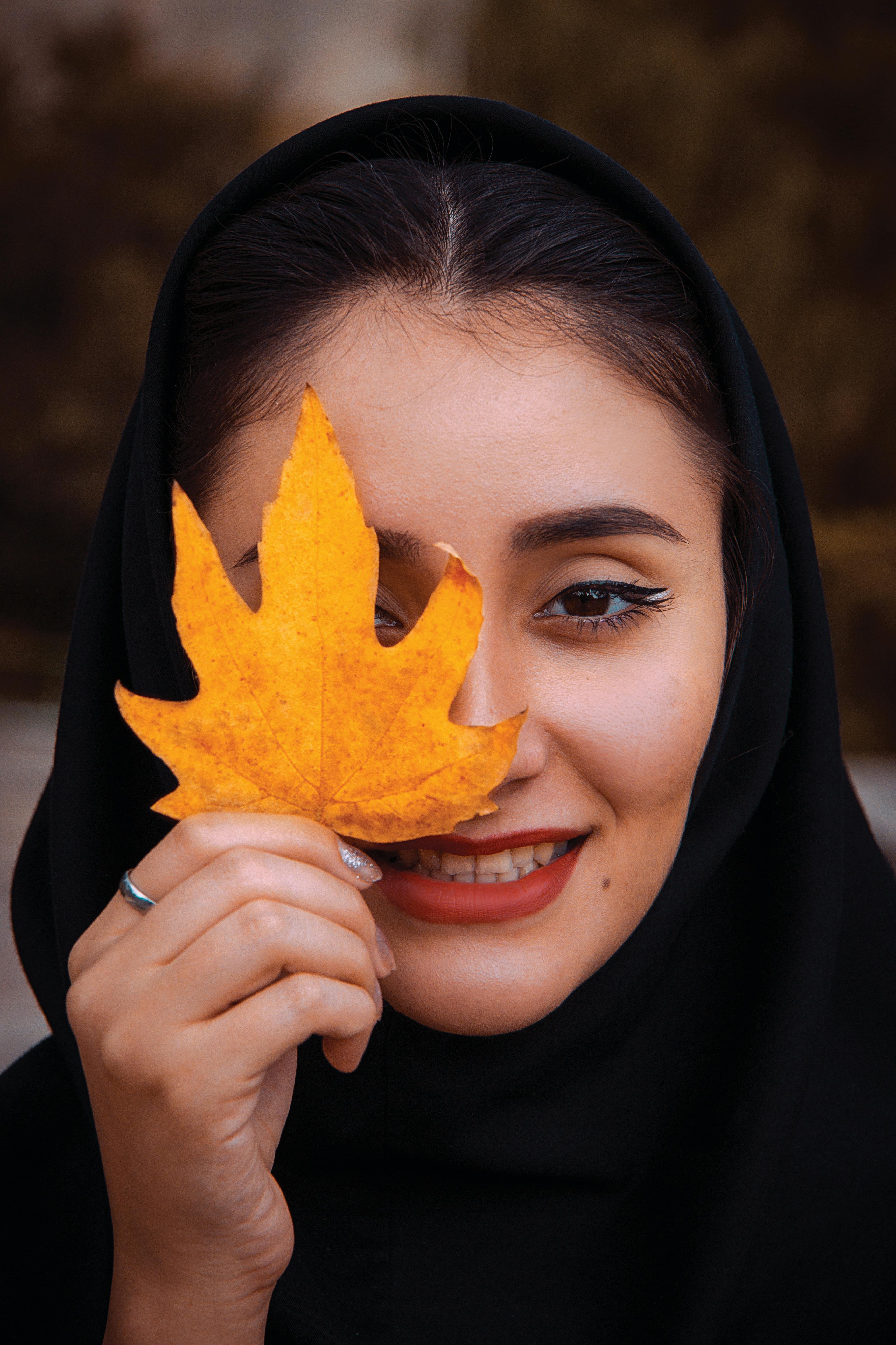 woman holding a maple leaf