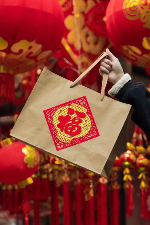 Free Celebrate Chinese New Year with a decorative paper bag amidst vibrant red lanterns. Stock Photo