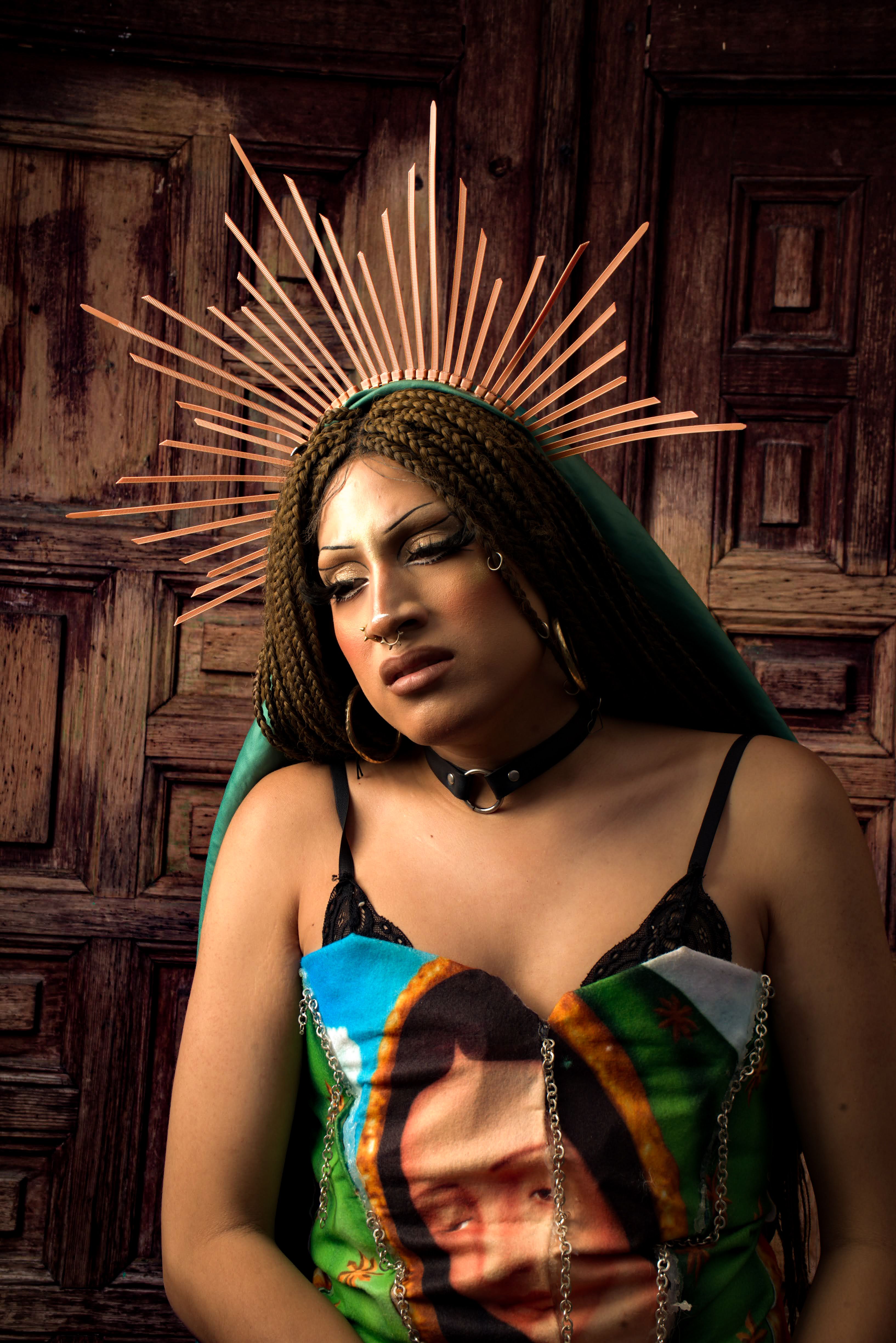 Woman with decorative halo posing against a rustic wooden door, showcasing unique style.
