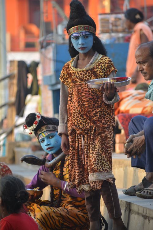 Free Children wearing traditional costumes and blue face paint participate in a cultural festival. Stock Photo