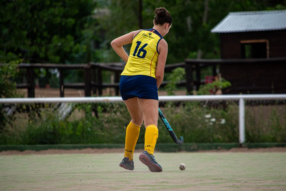 Field hockey player wearing a team uniform on the field