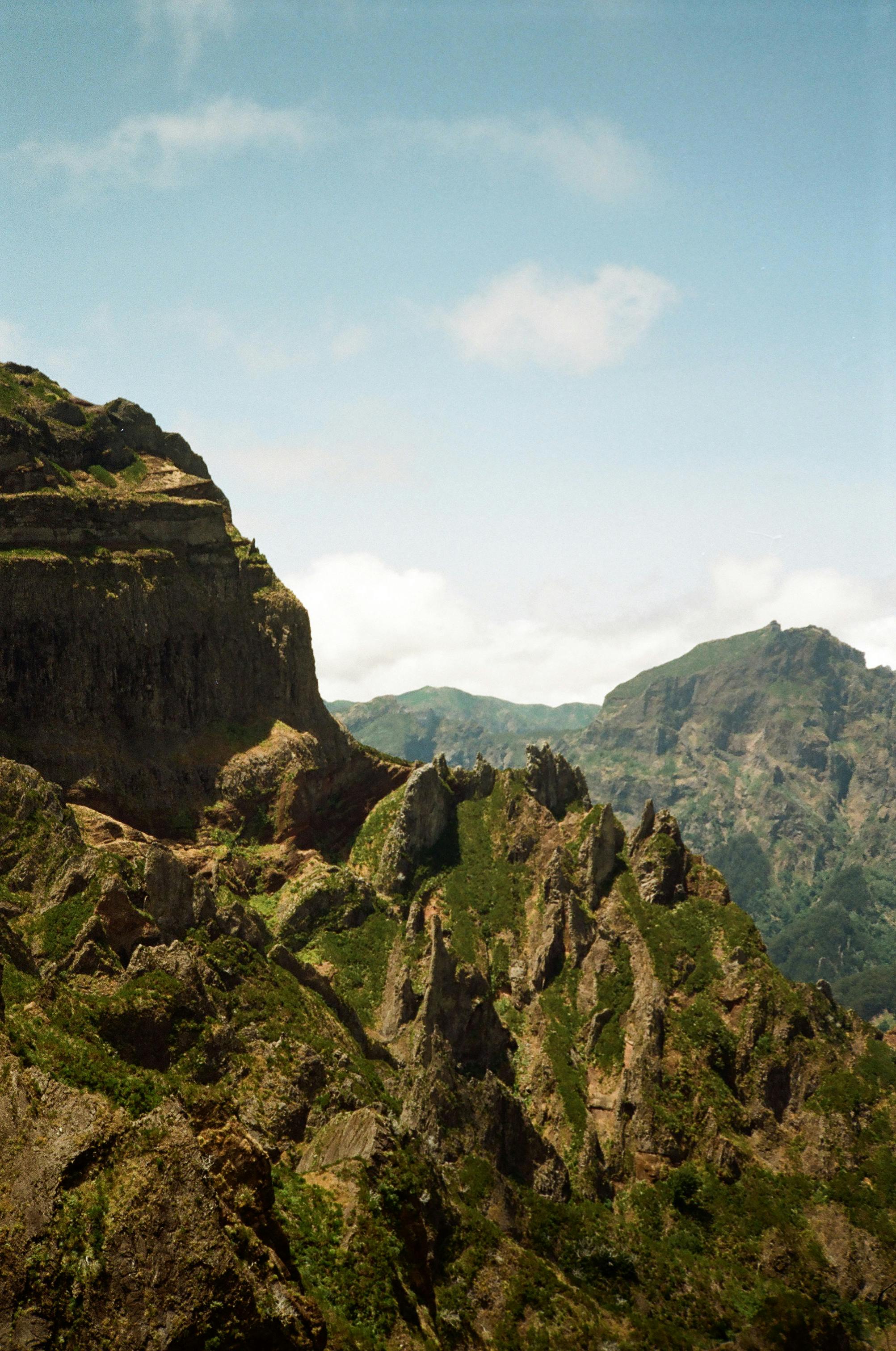 Breathtaking view of rugged mountains in Madeira, Portugal under a clear blue sky.