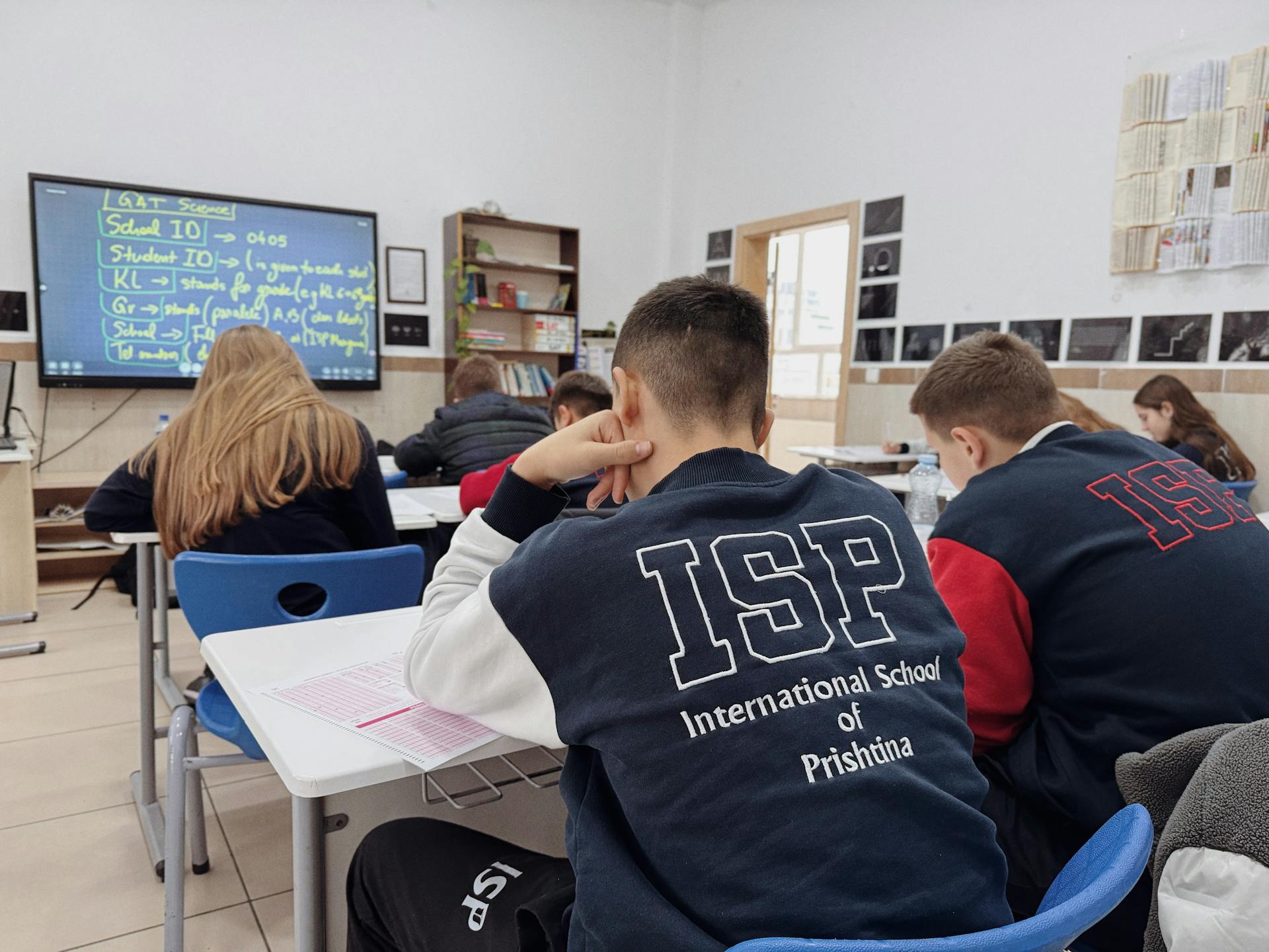 Students attentively learning in a classroom at the International School of Prishtina.