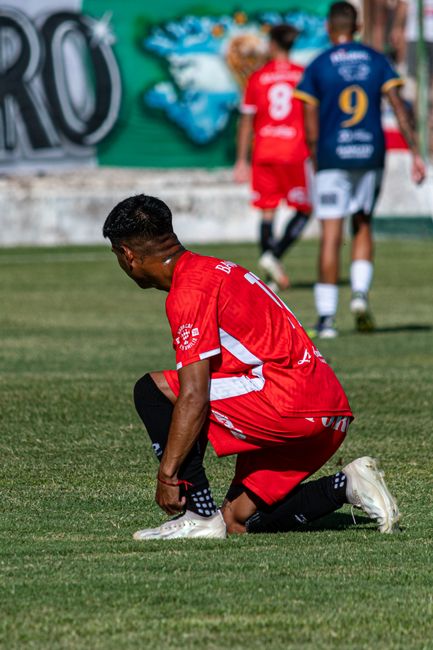 soccer player red white jersey stadium