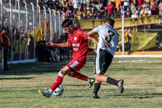 Two soccer players compete fiercely during an exciting outdoor match.