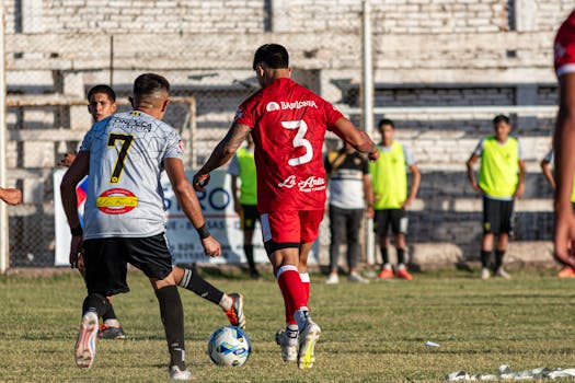 Exciting soccer match between two teams in vibrant jerseys, showcasing athletic skill and team spirit.