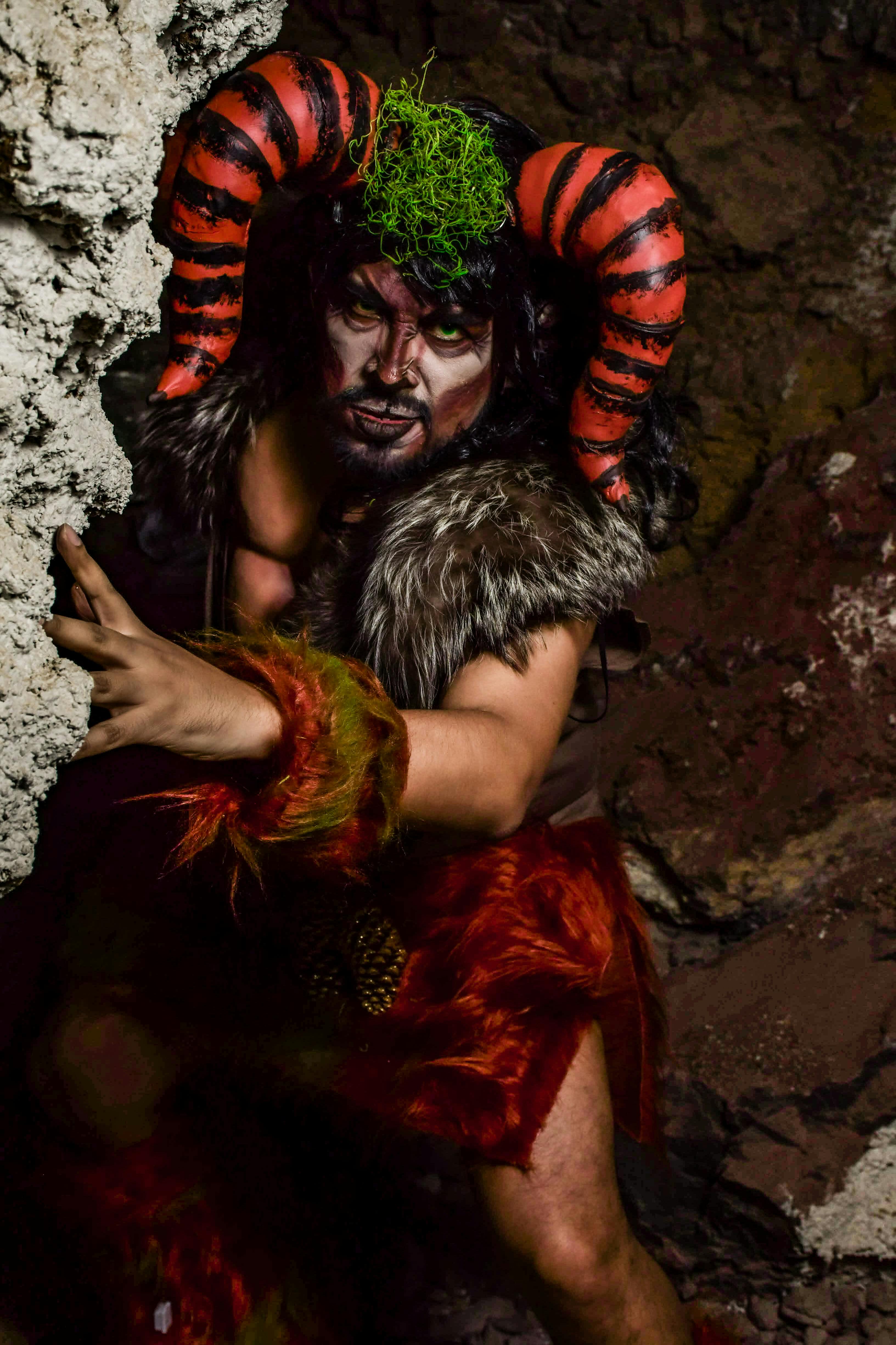 A mythical creature with horns lurking in a dark cave, embodying fantasy and mystery.