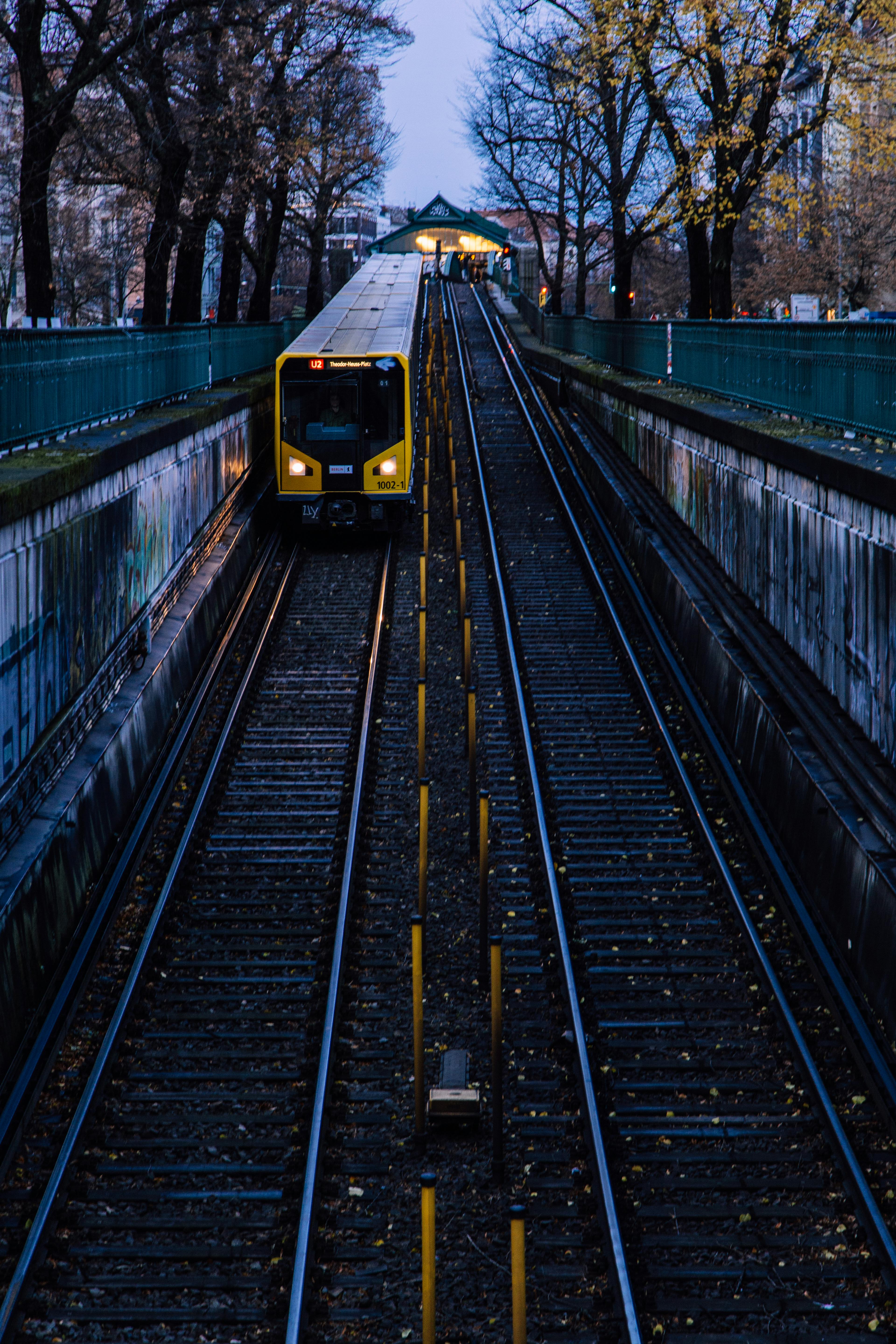 yellow train approaching metropolitan station